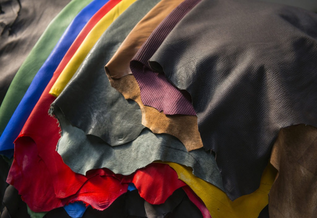 Overlapping view of different colours of leather.